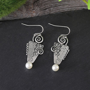 Inverted triangle with pearl earrings