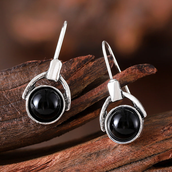 Compact round earrings with black cat's eye stones