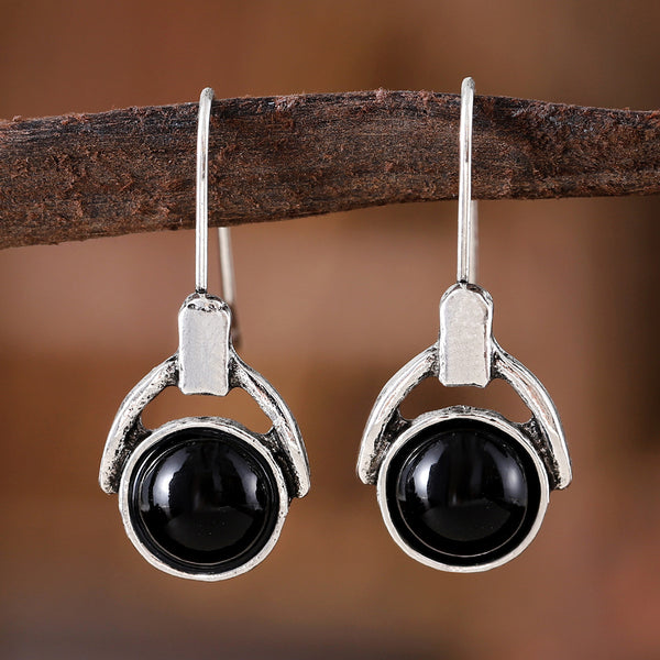 Compact round earrings with black cat's eye stones