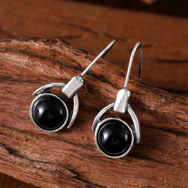 Compact round earrings with black cat's eye stones